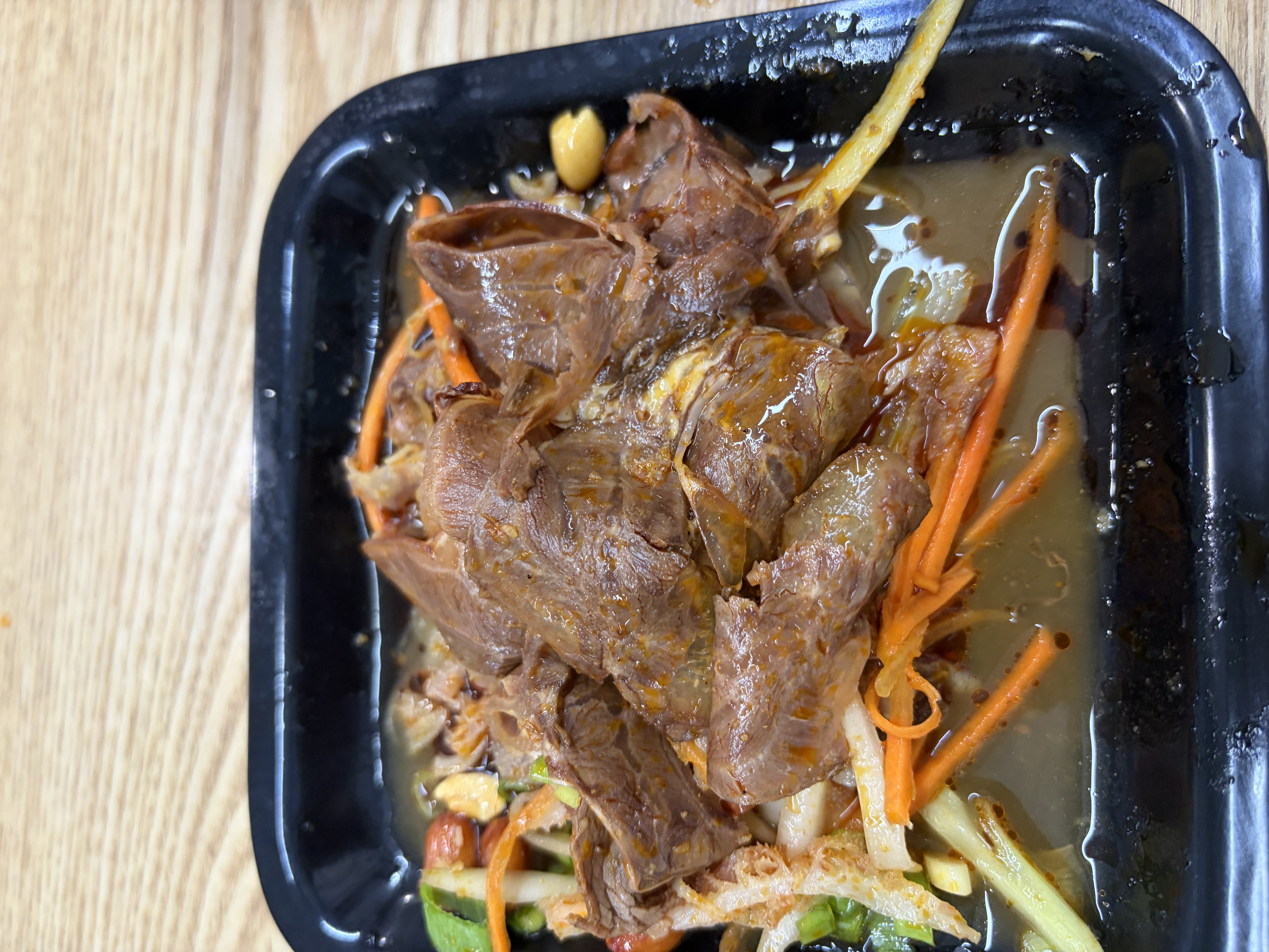 Cold Yunnan shaved beef and tripe over julienned carrot, cucumber and peanuts in chili oil